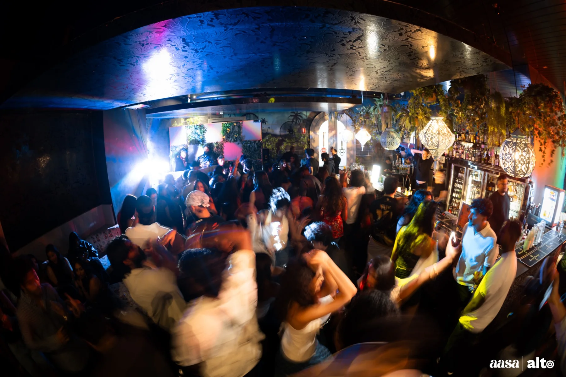 Packed Melbourne dance floor moving under blue and amber lights