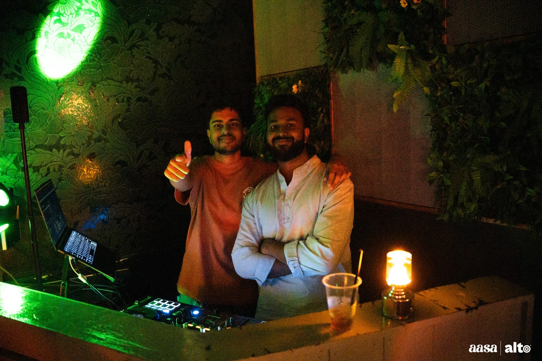 DJ Bhargav and another performer smiling behind the booth