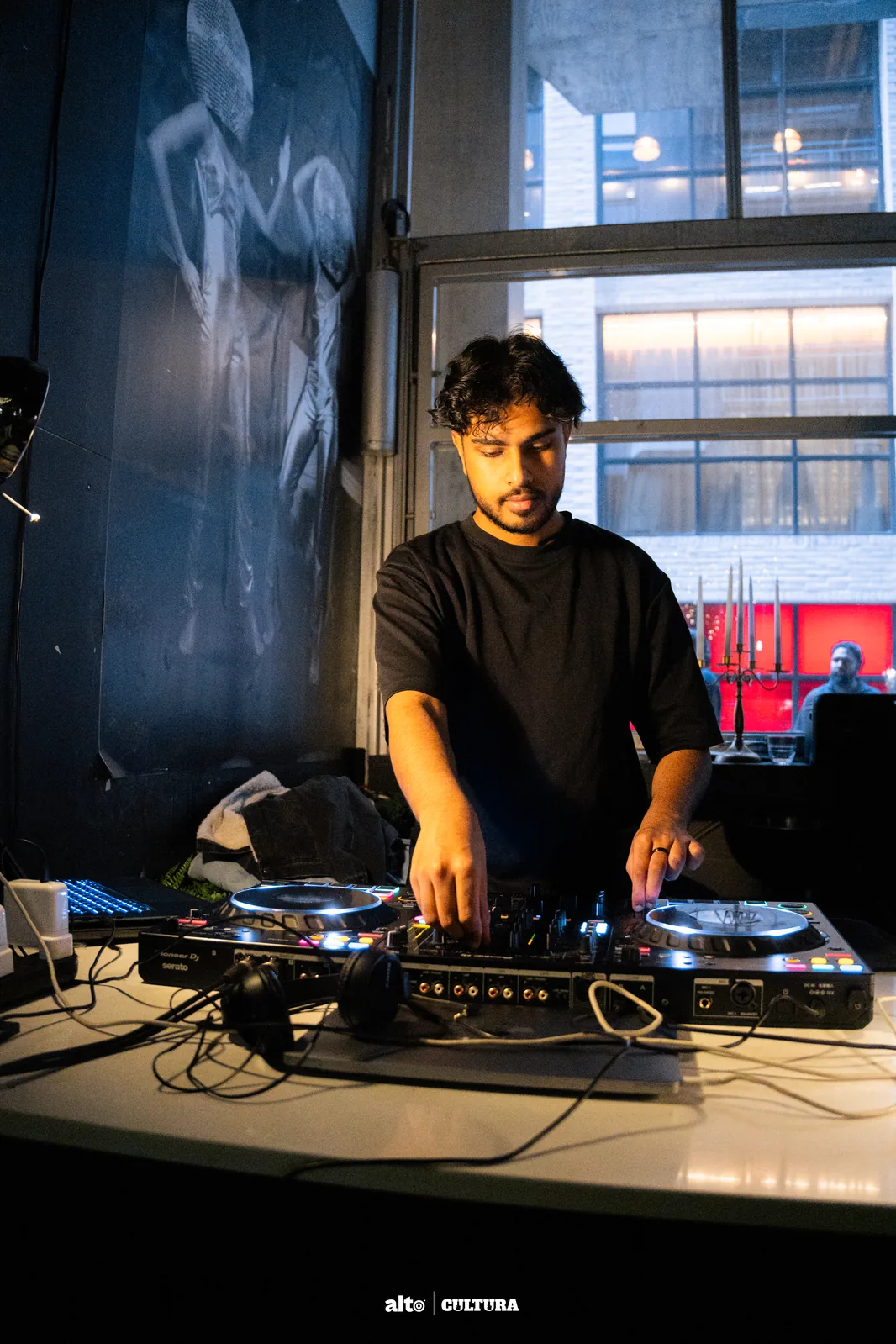 DJ Bhargav at the decks during a daytime event